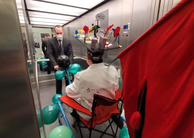 Bing on top of the PhD trolley, Pierre pulling it into an elevator