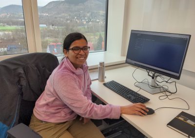 Rupali sitting at her office desk